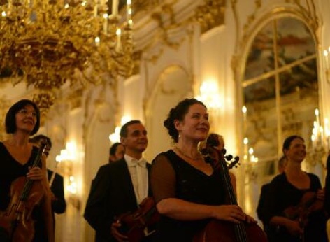Some of the musicians of the Schoenbrunn Palace Orchestra on their way to a concert in the Schoenbrunn Orangery